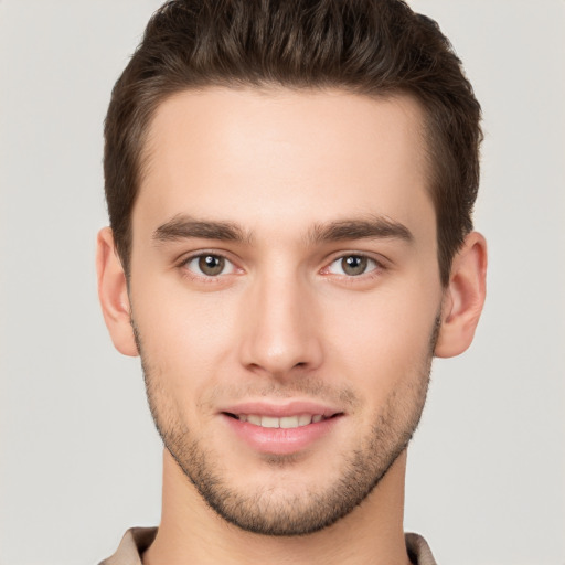 Joyful white young-adult male with short  brown hair and brown eyes