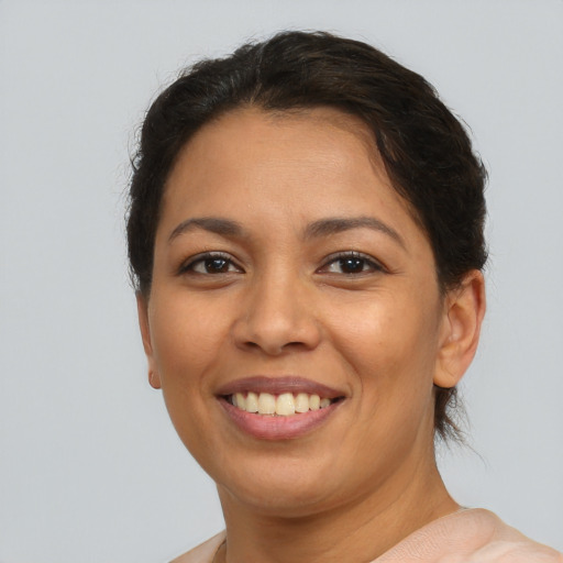 Joyful latino young-adult female with short  brown hair and brown eyes