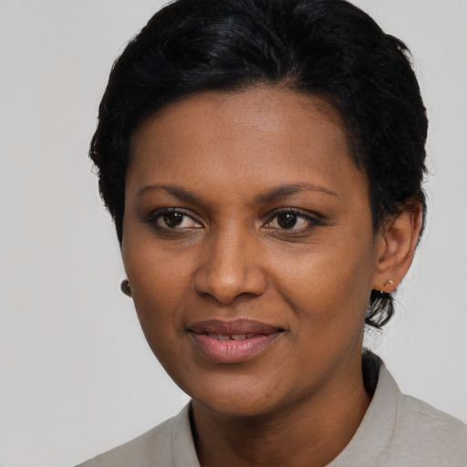 Joyful black young-adult female with short  black hair and brown eyes