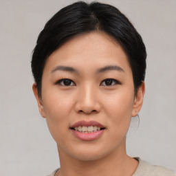 Joyful asian young-adult female with short  black hair and brown eyes