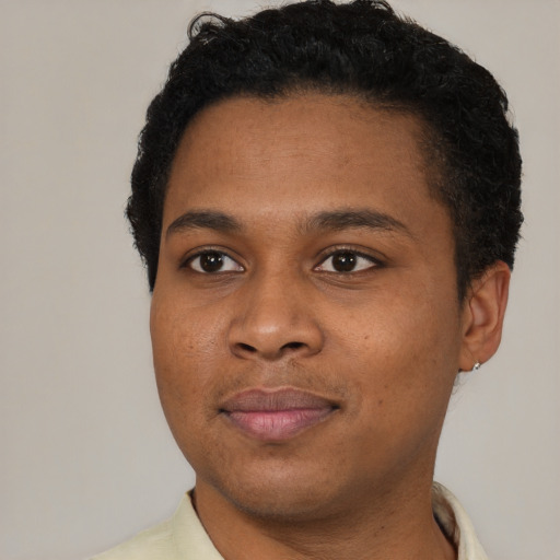 Joyful black young-adult male with short  black hair and brown eyes