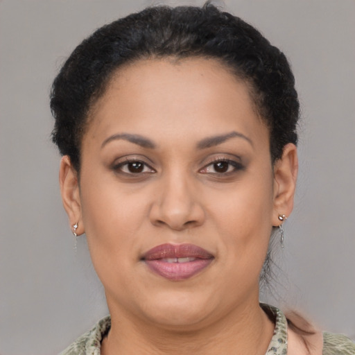 Joyful latino adult female with short  brown hair and brown eyes