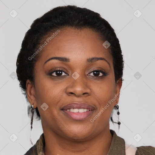 Joyful black adult female with medium  brown hair and brown eyes