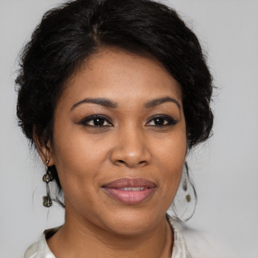 Joyful black young-adult female with medium  brown hair and brown eyes