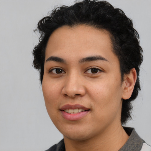 Joyful latino young-adult female with short  black hair and brown eyes