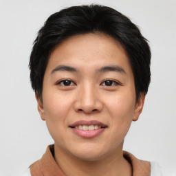 Joyful asian young-adult male with short  brown hair and brown eyes