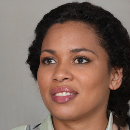 Joyful black young-adult female with medium  black hair and brown eyes