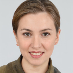 Joyful white young-adult female with short  brown hair and grey eyes