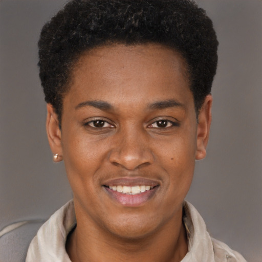 Joyful black young-adult male with short  brown hair and brown eyes