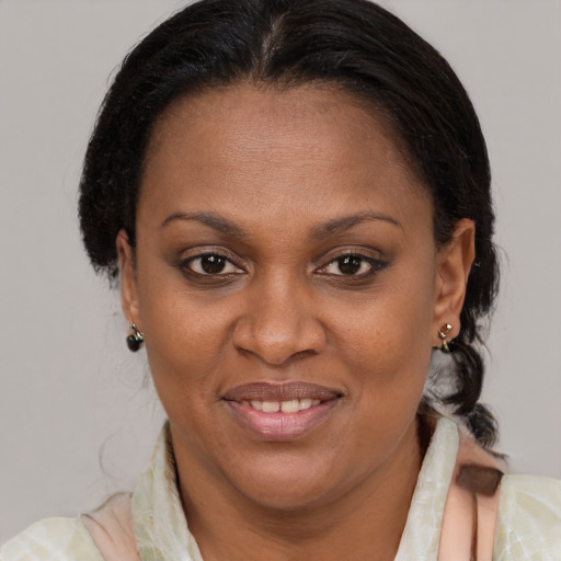 Joyful black adult female with medium  brown hair and brown eyes