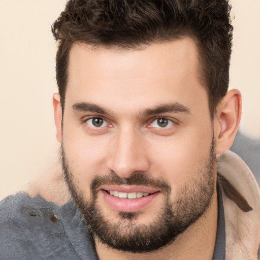 Joyful white young-adult male with short  brown hair and brown eyes