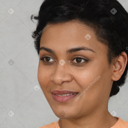 Joyful latino young-adult female with short  black hair and brown eyes