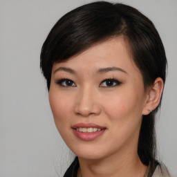 Joyful asian young-adult female with medium  brown hair and brown eyes