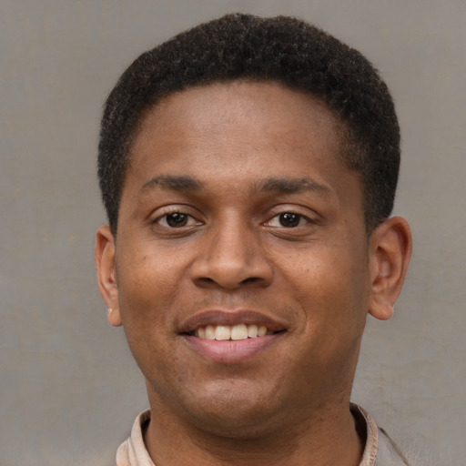 Joyful latino young-adult male with short  brown hair and brown eyes