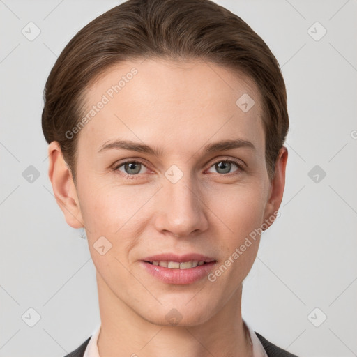 Joyful white young-adult female with short  brown hair and grey eyes