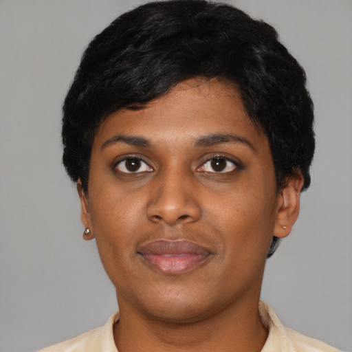 Joyful black young-adult female with short  black hair and brown eyes