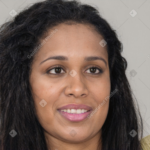 Joyful black young-adult female with long  brown hair and brown eyes