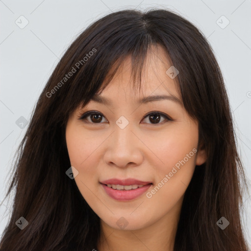 Joyful asian young-adult female with long  brown hair and brown eyes