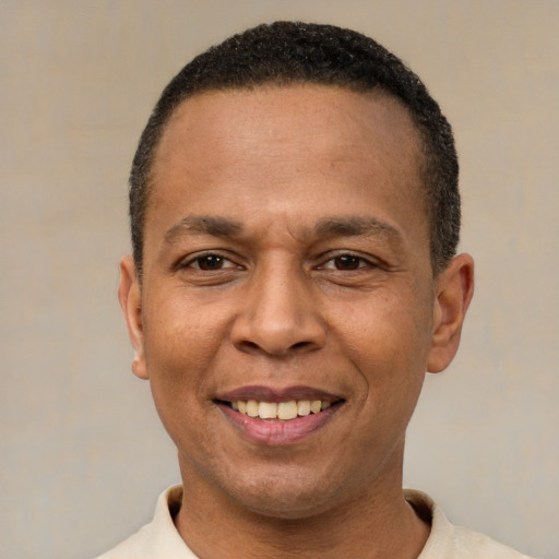 Joyful latino adult male with short  black hair and brown eyes