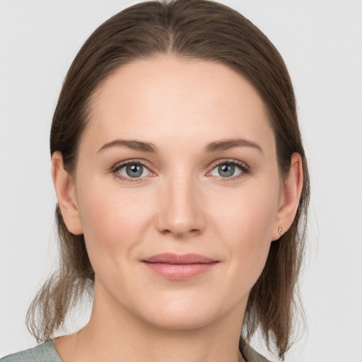 Joyful white young-adult female with medium  brown hair and grey eyes