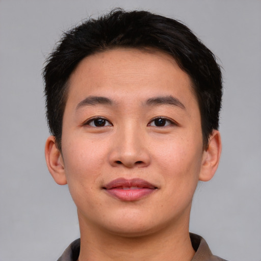 Joyful asian young-adult male with short  brown hair and brown eyes