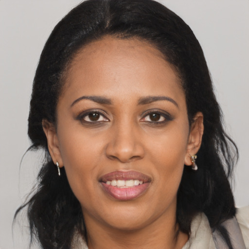 Joyful black young-adult female with medium  brown hair and brown eyes