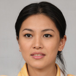 Joyful asian young-adult female with medium  brown hair and brown eyes