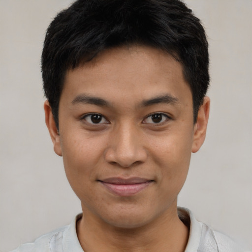 Joyful asian young-adult male with short  brown hair and brown eyes