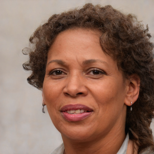 Joyful black adult female with medium  brown hair and brown eyes