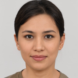 Joyful asian young-adult female with short  brown hair and brown eyes