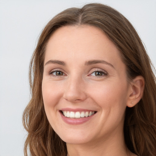 Joyful white young-adult female with long  brown hair and grey eyes