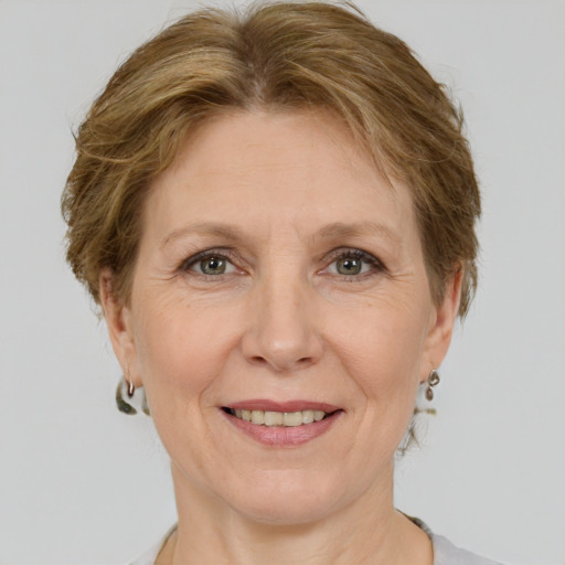 Joyful white adult female with medium  brown hair and grey eyes