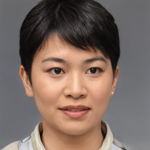 Joyful asian young-adult female with short  brown hair and brown eyes