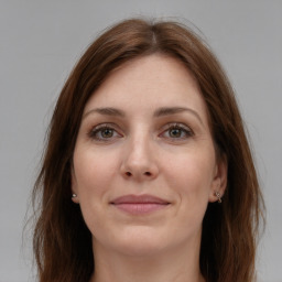 Joyful white young-adult female with long  brown hair and grey eyes