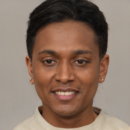 Joyful latino young-adult male with short  black hair and brown eyes