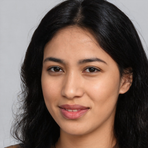 Joyful latino young-adult female with long  black hair and brown eyes