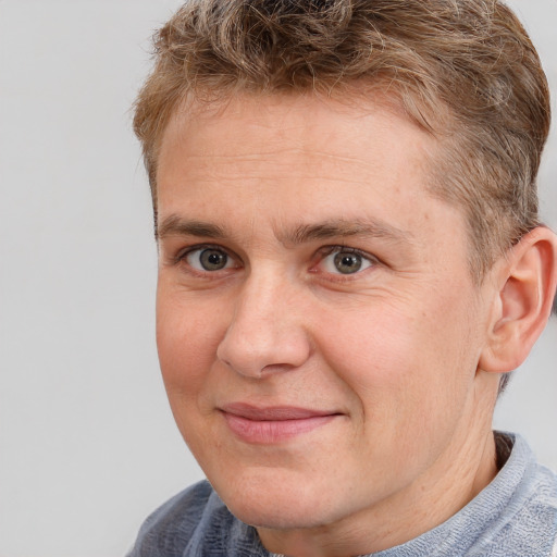 Joyful white adult male with short  brown hair and grey eyes