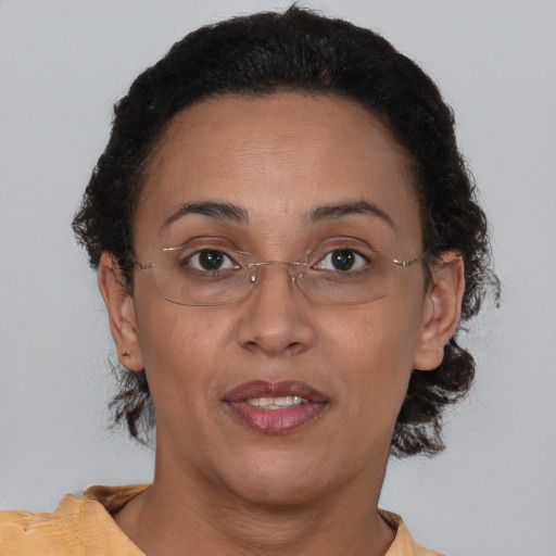 Joyful black adult female with short  brown hair and brown eyes