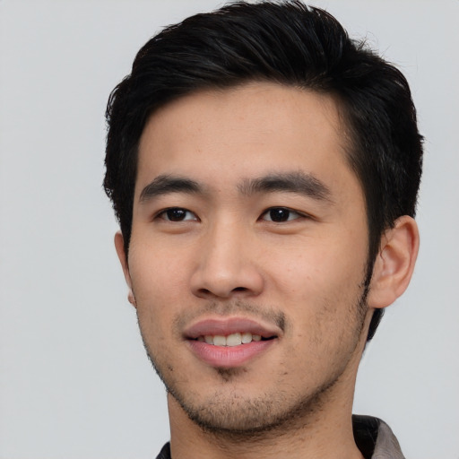 Joyful asian young-adult male with short  black hair and brown eyes