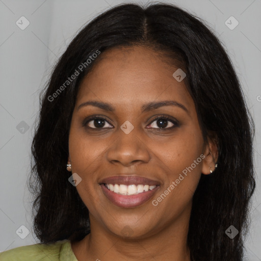 Joyful black young-adult female with long  brown hair and brown eyes