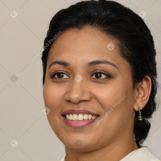 Joyful latino young-adult female with medium  brown hair and brown eyes