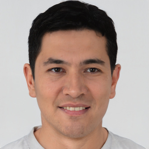 Joyful white young-adult male with short  black hair and brown eyes