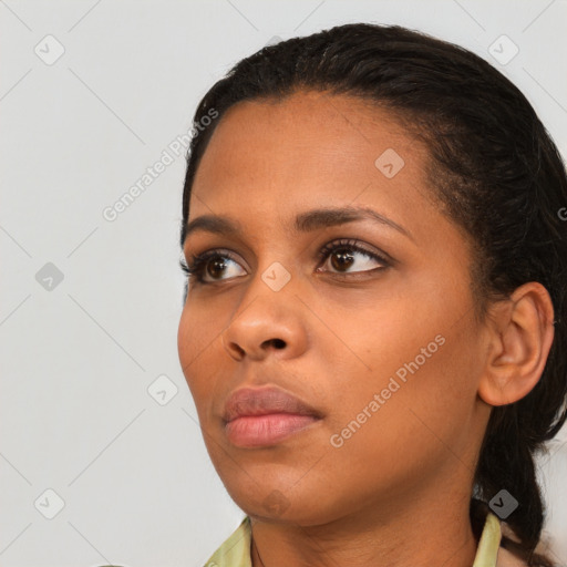 Neutral black young-adult female with medium  brown hair and brown eyes