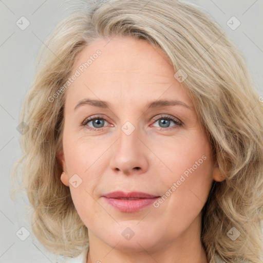 Joyful white adult female with medium  brown hair and blue eyes