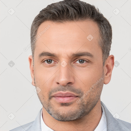 Neutral white adult male with short  black hair and brown eyes