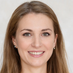 Joyful white young-adult female with long  brown hair and green eyes