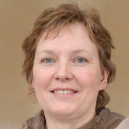 Joyful white adult female with medium  brown hair and blue eyes