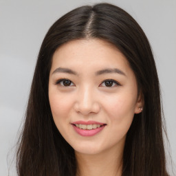 Joyful asian young-adult female with long  brown hair and brown eyes