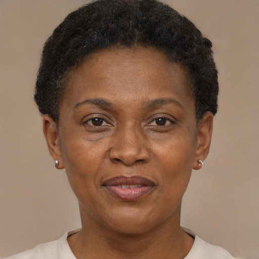 Joyful black adult female with short  brown hair and brown eyes