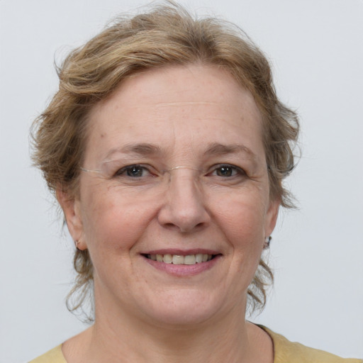 Joyful white adult female with medium  brown hair and blue eyes